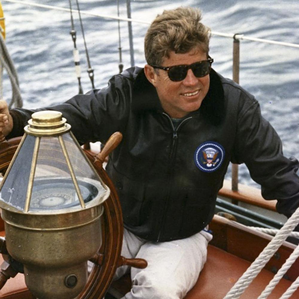 JFK Wearing a jacket on a boat