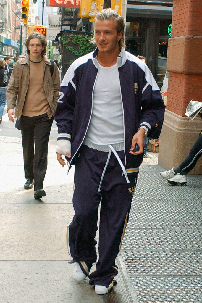 David Beckham wearing athleisure walking down the street.