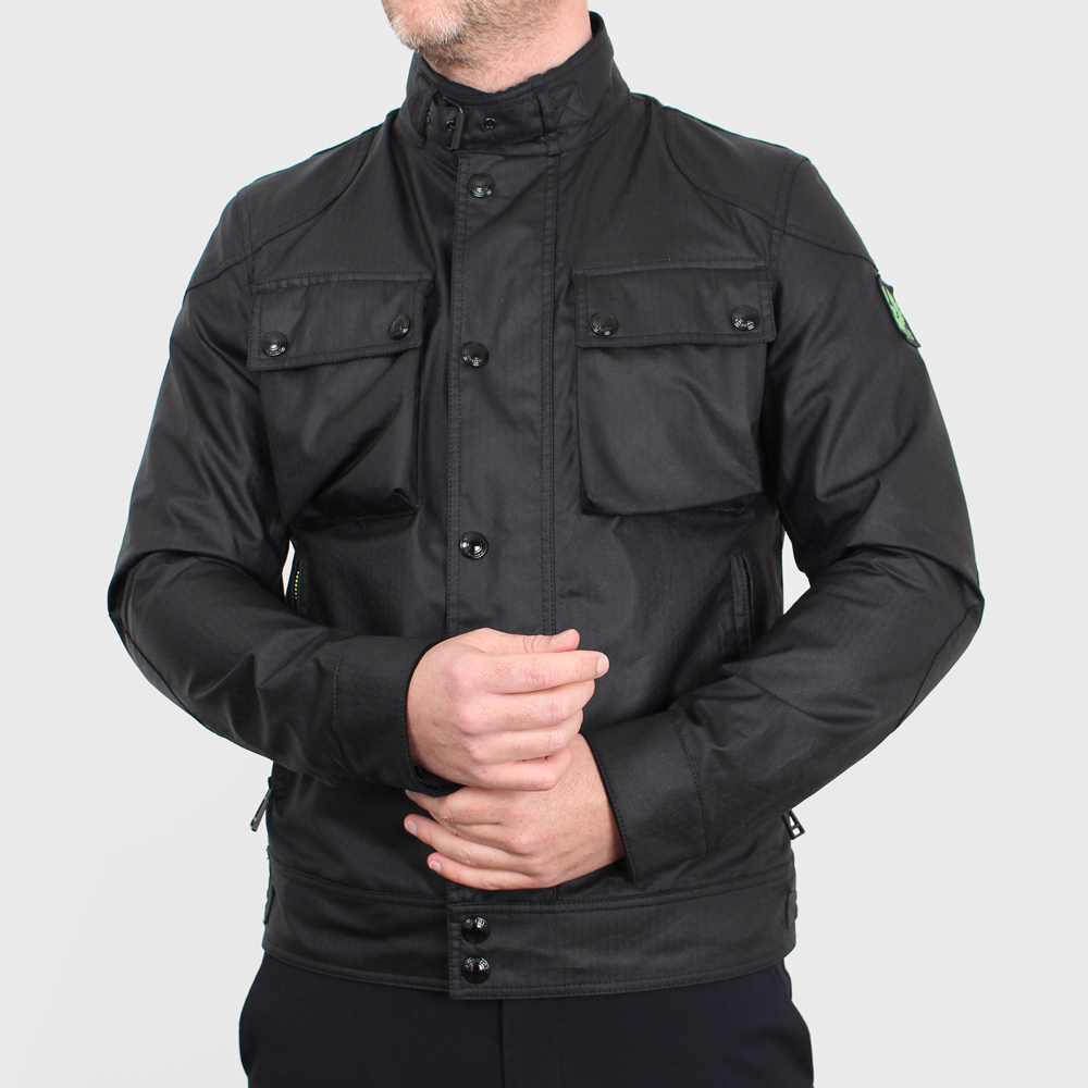 Man wearing jacket done up with arms crossed