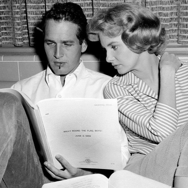 Paul Newman wearing a shirt looking at a piece of paper