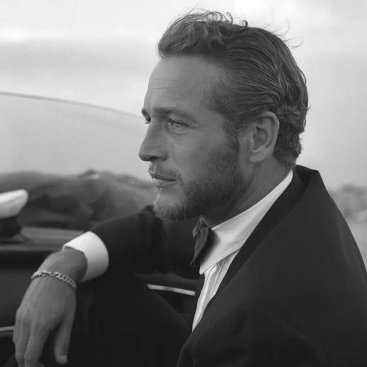 Paul Newman wearing a suit looking into the distance