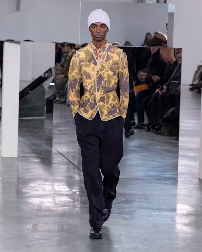 Model walking in yellow waistcoat