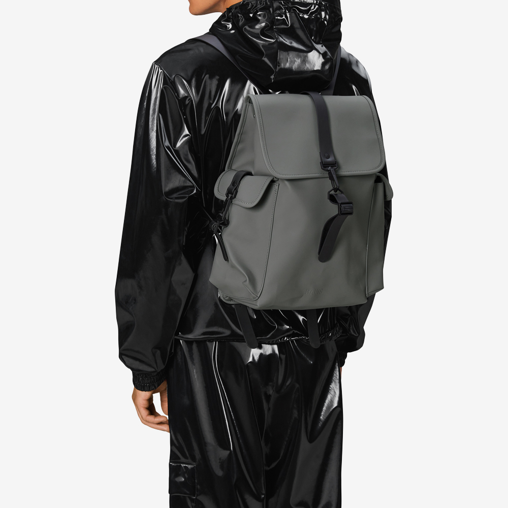 Model wearing grey backpack