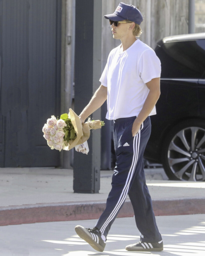 Man walking carrying flowers