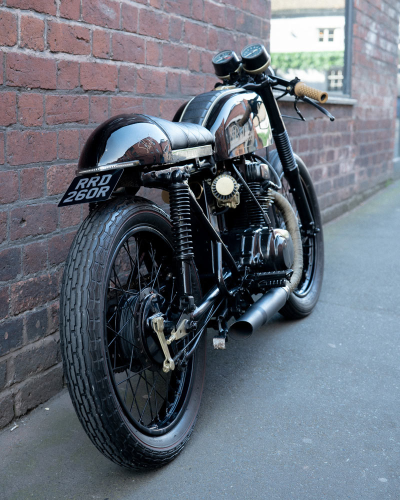 A motorcycle parked next to a wall