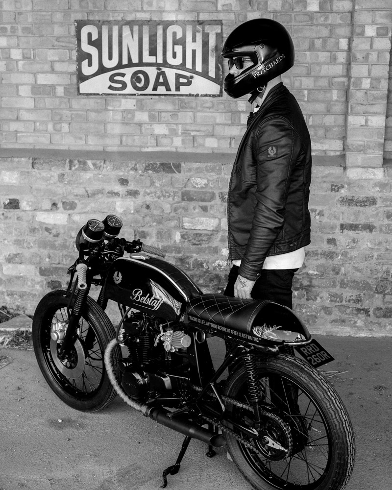 Man stood next to motorcycle with helmet on