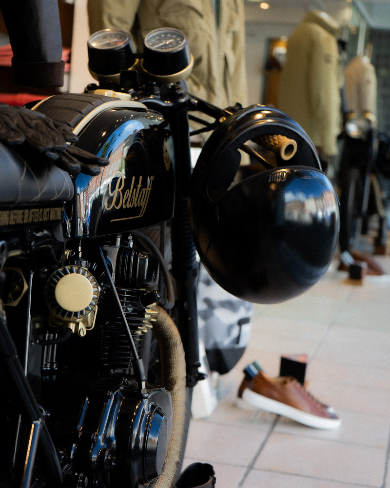 A closeup image of a helmet balancing on the handlebars of a motorcycle