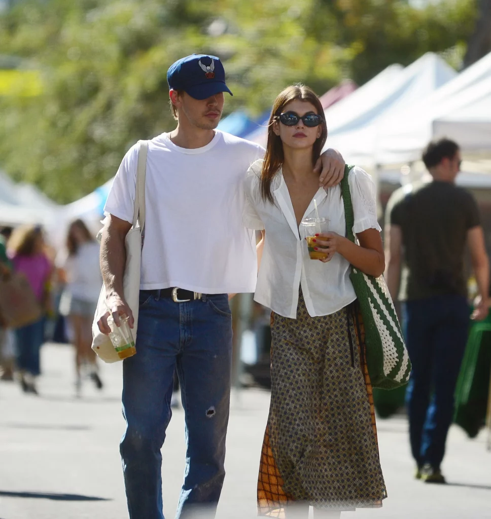 Man walking down street with his arm around a woman