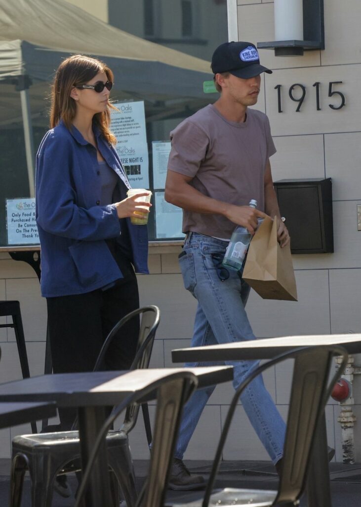 Man with bags in hand walking with woman.