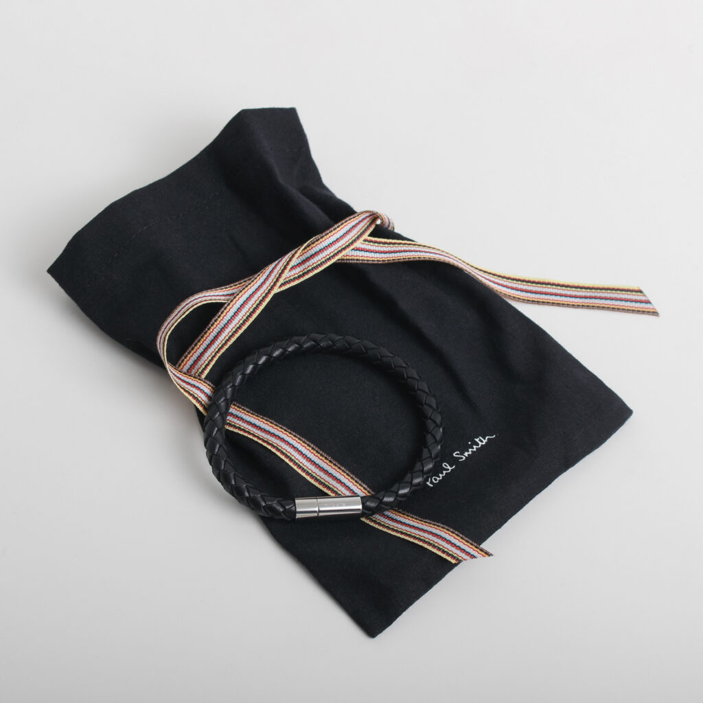 Bracelet lying across pouch