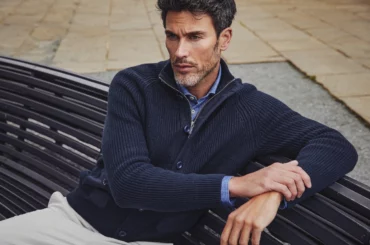Man sat on a bench and holding his arm