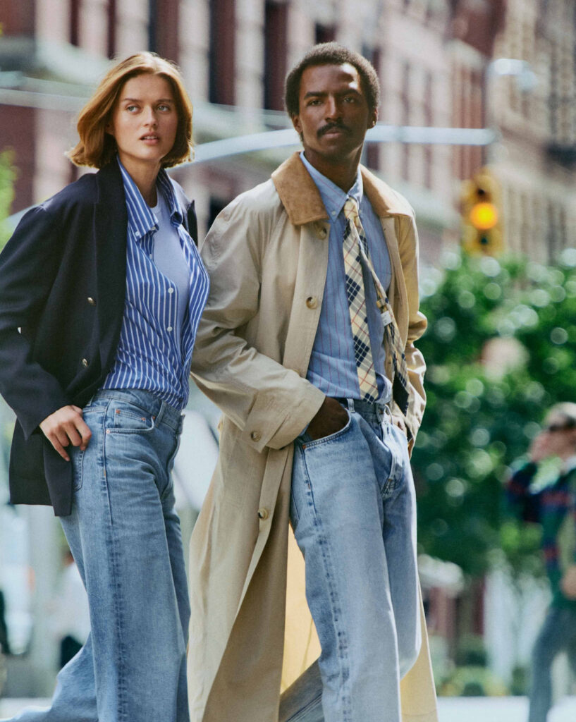 A smartly dressed man and woman walking in a city