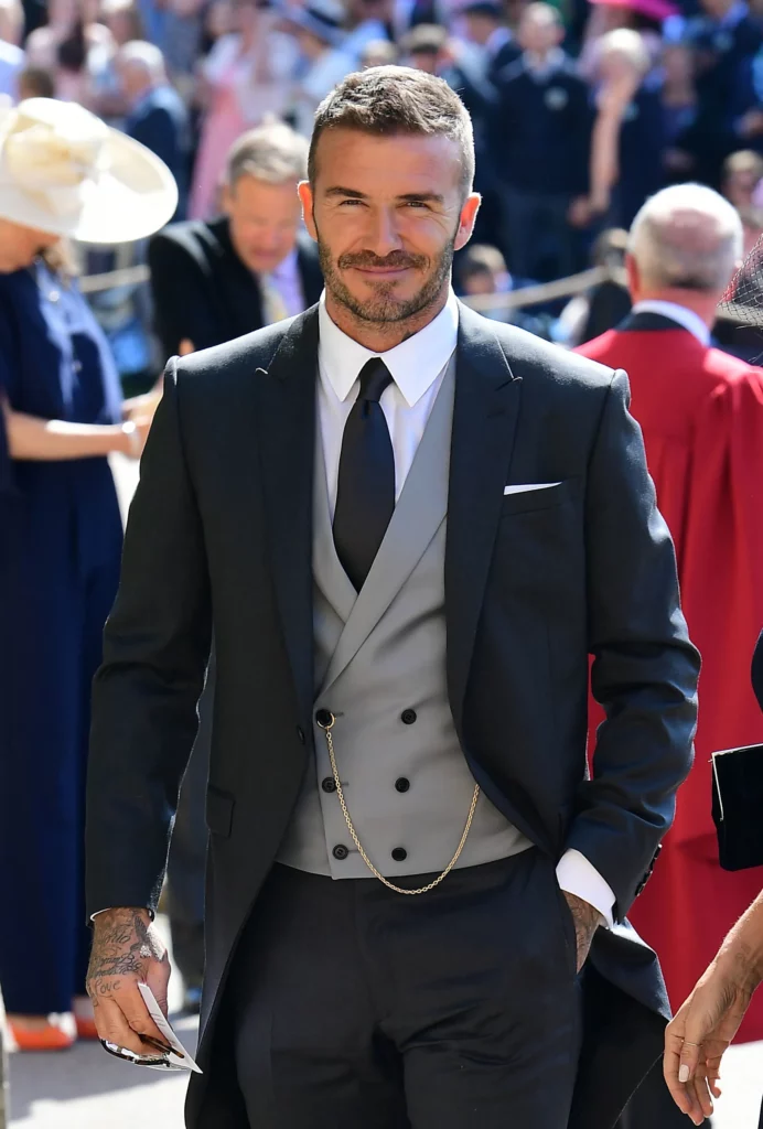 Man walking in a three piece suit with his hand in his pocket