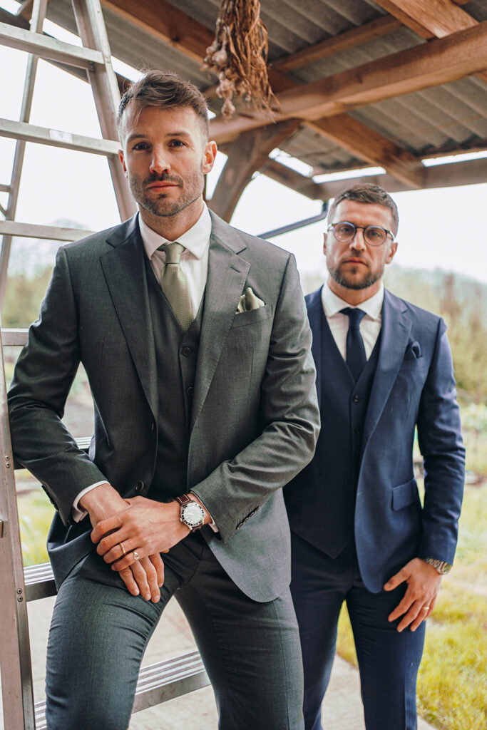 Two men dressed in suits stood next to each other