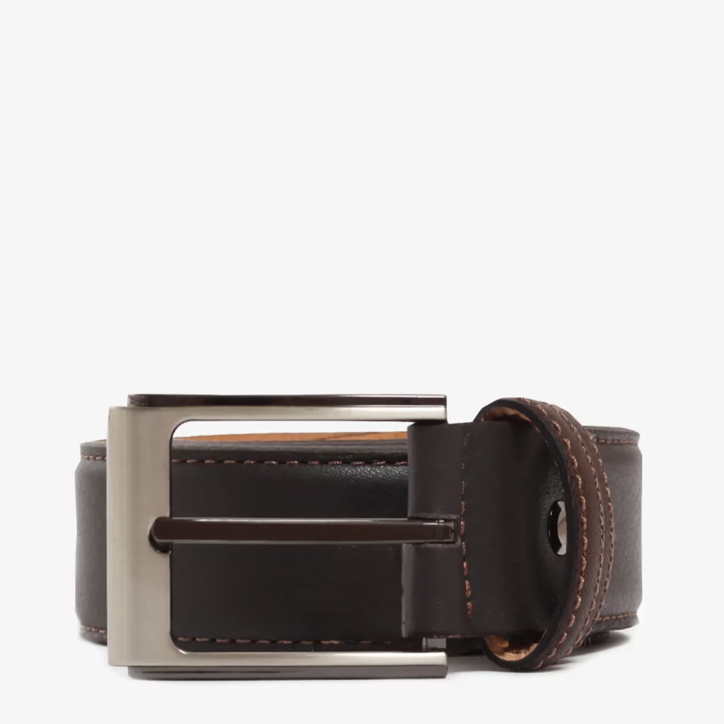 A closeup image of a rolled up brown belt against a light grey background