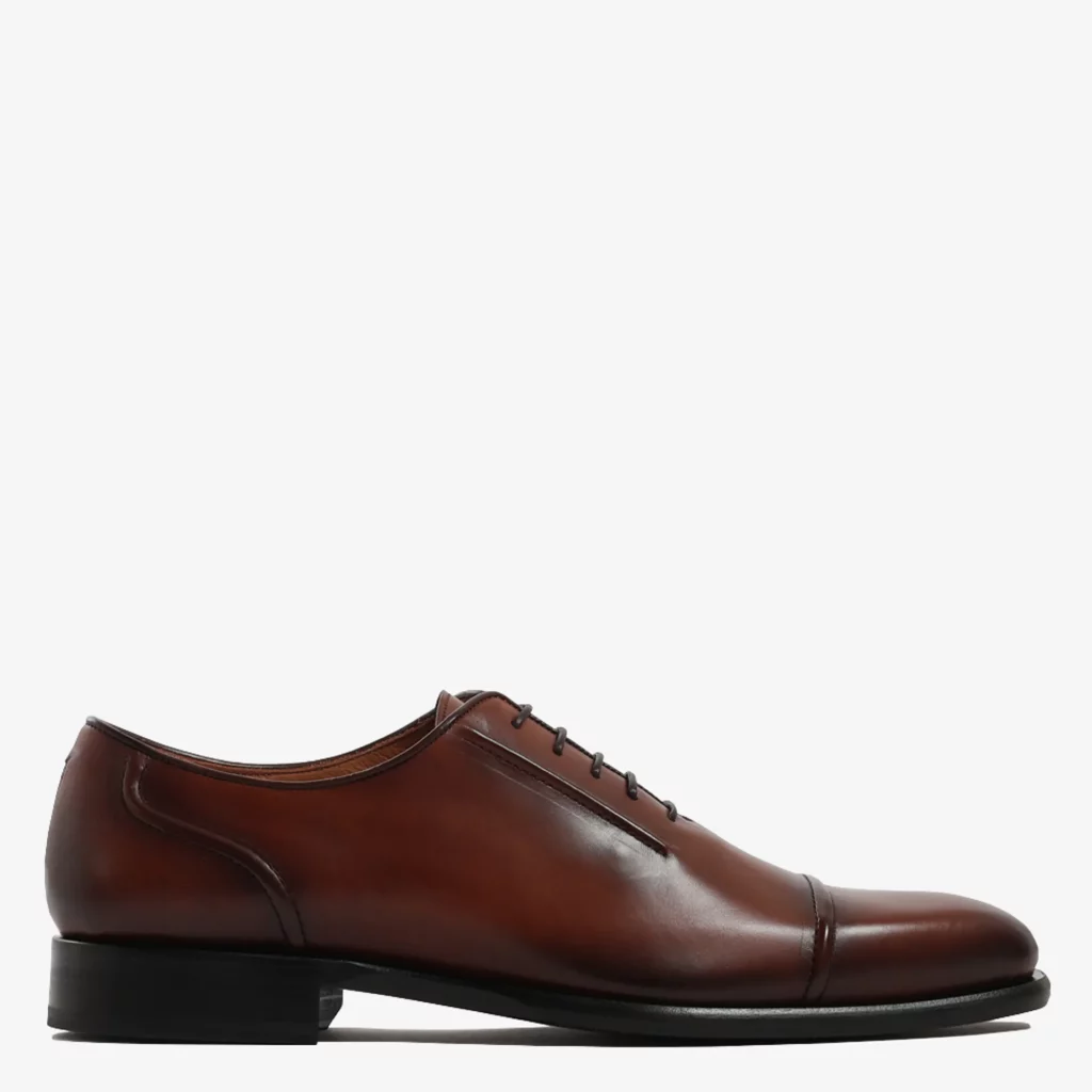 A photo of a brown shoe against a white background
