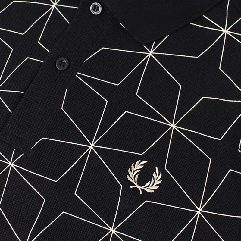 Black polo shirt with large star pattern on it